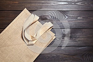 Reusable shopping bag, natural textile fiber, eco hessian or jute sack on brown wooden background