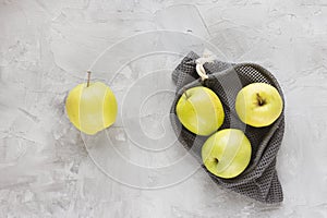Reusable shopping mesh bag on gray with apples background. Zero waste, no plastic