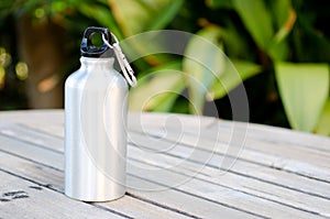 Reusable water bottle on a wooden table photo