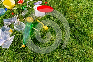 Reuse garbage, recycle, plastic free. Food plastic packaging, trash on green grass background. Recycling plastic