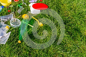 Reuse garbage, recycle, plastic free. Food plastic packaging, trash on green grass background. Recycling plastic. Environmental