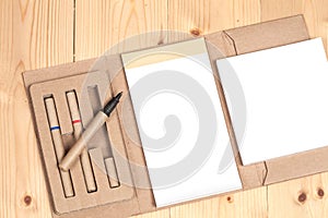 Reuse Note book with pen on a wooden