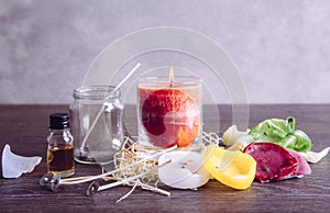 Reusing old candles leftovers and making melting a new one: various ingredients on table: candle wicks, glass jar, old candles wax