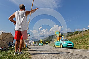 Spectators and advertsing caravan on the roads of Tour de France