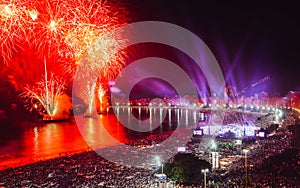 Revellers, both locals and tourist, enjoy the breath-taking New Years fireworks display along Copacabana Beach, Rio de photo