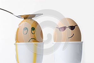 Revenge, punishment, violence, sadness, unhappiness, victim concept, faces drawn on boiled eggs