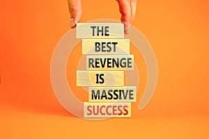 Revenge or success symbol. Concept words The best revenge is massive success on wooden blocks. Bussinesman hand. Beautiful orange