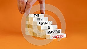 Revenge or success symbol. Concept words The best revenge is massive success on wooden blocks. Bussinesman hand. Beautiful orange