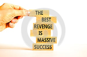 Revenge or success symbol. Concept words The best revenge is massive success on wooden blocks. Bussinesman hand. Beautiful white
