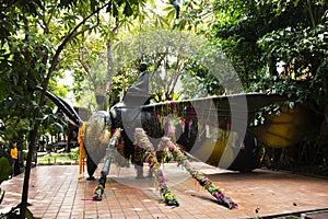 Reverend Luang Phor Kong sit on Giant large Phaya Hornet wasp in Khum Khun Phaen garden park in Wat Khae temple for thai people