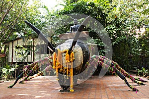 Reverend Luang Phor Kong sit on Giant large Phaya Hornet wasp in Khum Khun Phaen garden park in Wat Khae temple for thai people