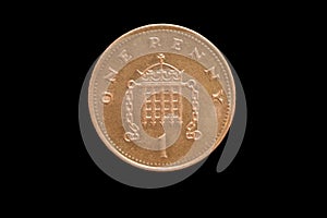 Reverse of the Great Britain one penny coin of 1996 isolated on a black background