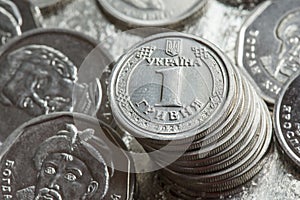 Reverse of the one hryvnia coin. Stack of Ukrainian hryvnia coins. Coinage photo