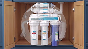 Reverse osmosis water purification system under sink. Water cleaning system installation