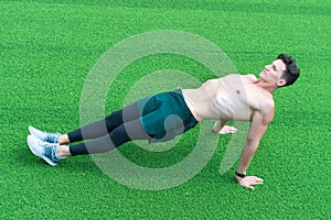 Reverse plank helps strengthen lower back, man exercising outdoors