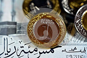 Reverse side of 1 SAR one Saudi Arabia riyals coin series 1438 AH 2016 isolated with other Saudi coins on 500 SAR five hundred