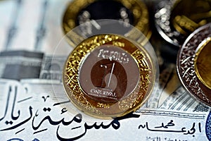 Reverse side of 1 SAR one Saudi Arabia riyals coin series 1438 AH 2016  with other Saudi coins on 500 SAR five hundred