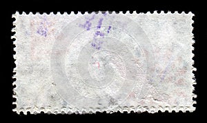 Reverse side of a postage stamp.