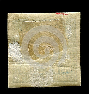 Reverse side of a postage stamp.