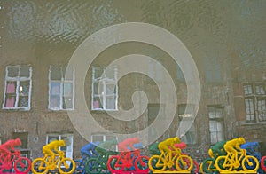 Reversed image concept: Plastic Cyclists on a river photo