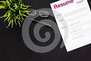 Review resumes of applicants set with glasses black work desk background top view mockup