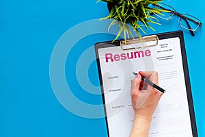 Review resumes of applicants set with glasses blue work desk background top view mockup