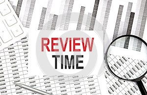 REVIEW TIME text on document with pen,graph and magnifier,calculator