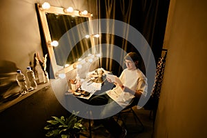 Reviewing Script Behind Dressing Room Table