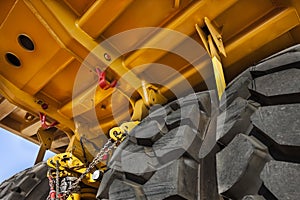 revision of suspension , double axle under a huge brand new yellow mining truck