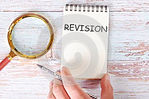 REVISION written on a blank sheet of a notebook
