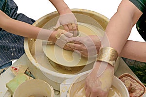 Revival of folk crafts. Shaping clay on pottery wheel. Creative lesson. Teacher and child