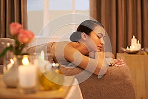 Revive your soul. A beautiful young woman relaxing on a massage table before her massage.