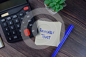 Revocable Trust write on sticky notes isolated on Wooden Table