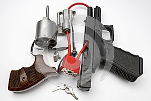 Revolver and automatic gun with cable lock , Locked disarmed and secured weapons , Gun safety in home concept