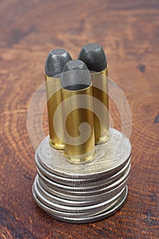 The Revolver cartridges and Silver Dollar Wild West period on wooden background