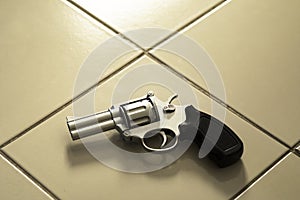 Revolver gun laying on room floor