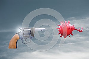 Revolver Gun shooting and kill the coronavirus influenza and grip in the blue sky with clouds . Protection against ``2019-nCoV` photo