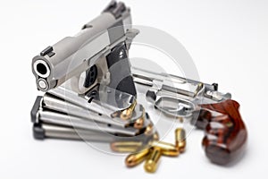 Revolver handgun and Automatic pistol with .45 bullets on white background