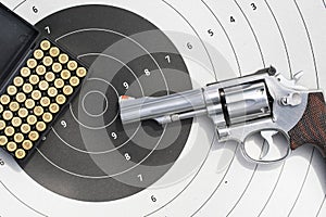 gun with 9mm bullets on the target