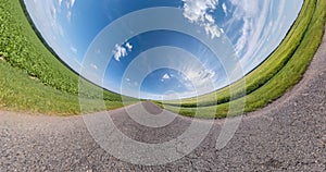 Revolves among fields with beautiful clear sky and white clouds. Little planet Transformation with curvature of space. loop rotate