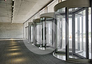 Revolving doors. The facade of a modern shopping center or station, an airport with revolving doors.