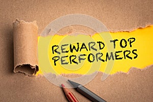 Reward top performers. Torn cardboard on a yellow background