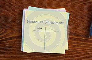 Reward vs punishment written on a note