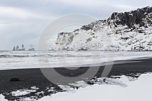Reynisfjall Cliffs and Snowy Black Beach