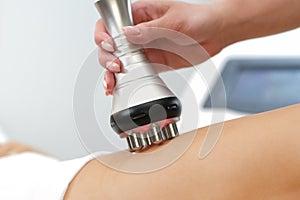 Rf lifting procedure on the legs, buttocks and back, hips of a woman in a beauty parlor