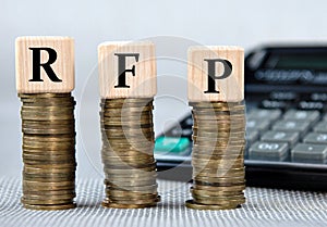 RFP - acronym on wooden cubes on the background of coins and calculator