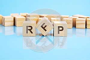 RFP text is made of wooden building blocks lying on the bright blue table, concept