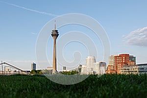 Rhein tower and promenade on riverside of Rhein River and cityscape at media harbour, in DÃ¼sseldorf, Germany.