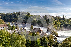 Rheinfall the large waterfall surround with green forest and blue sky background view from Neuhausen am Rheinfall railway station