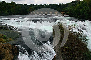 The Rheinfall waterfall and the arched bridge over the Rhein River near the town of Neuhausen in Switzerland